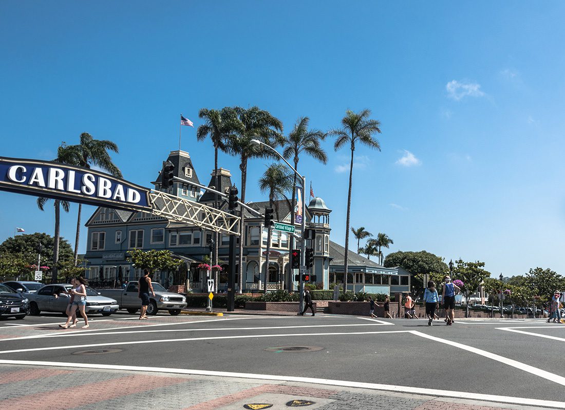 Carlsbad, CA - Carlsbad Village in California Displaying the Carlsbad Sign Over the Street on a Sunny Day